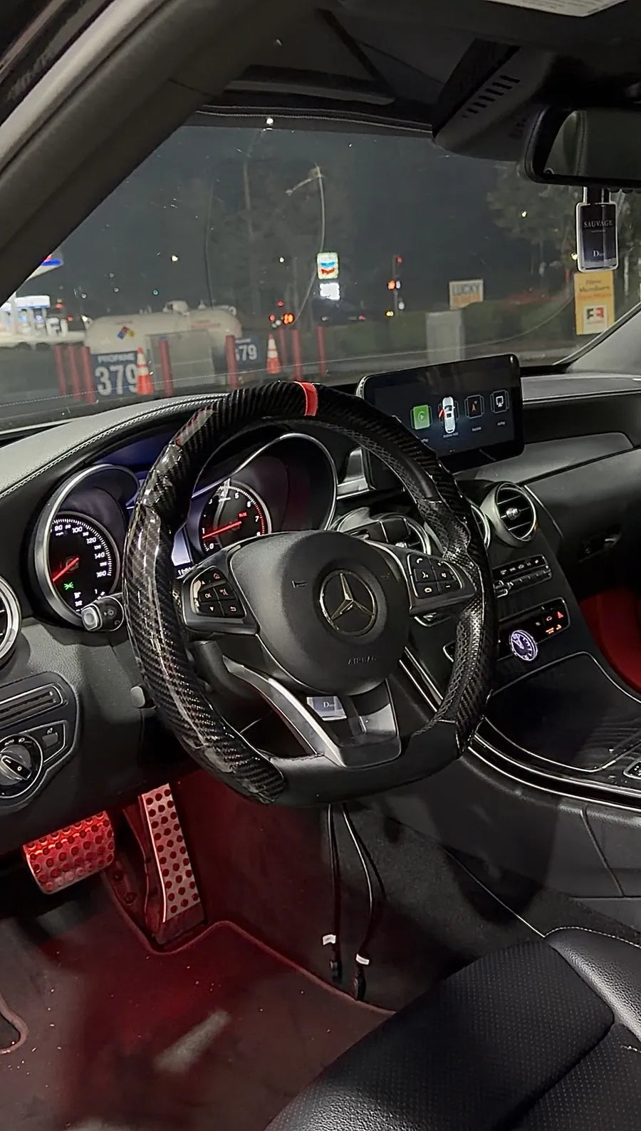 Carbon Red cover on a steering wheel at night with red footwell lighting